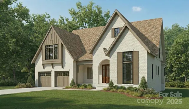 a front view of a house with a yard and trees