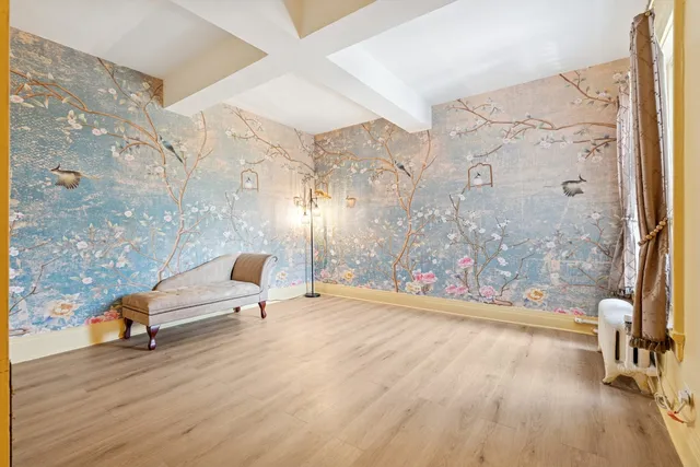 wooden floor with view of bathroom and shower