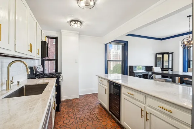 a kitchen with a sink a stove and cabinets
