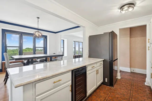a kitchen with center island and stainless steel appliances