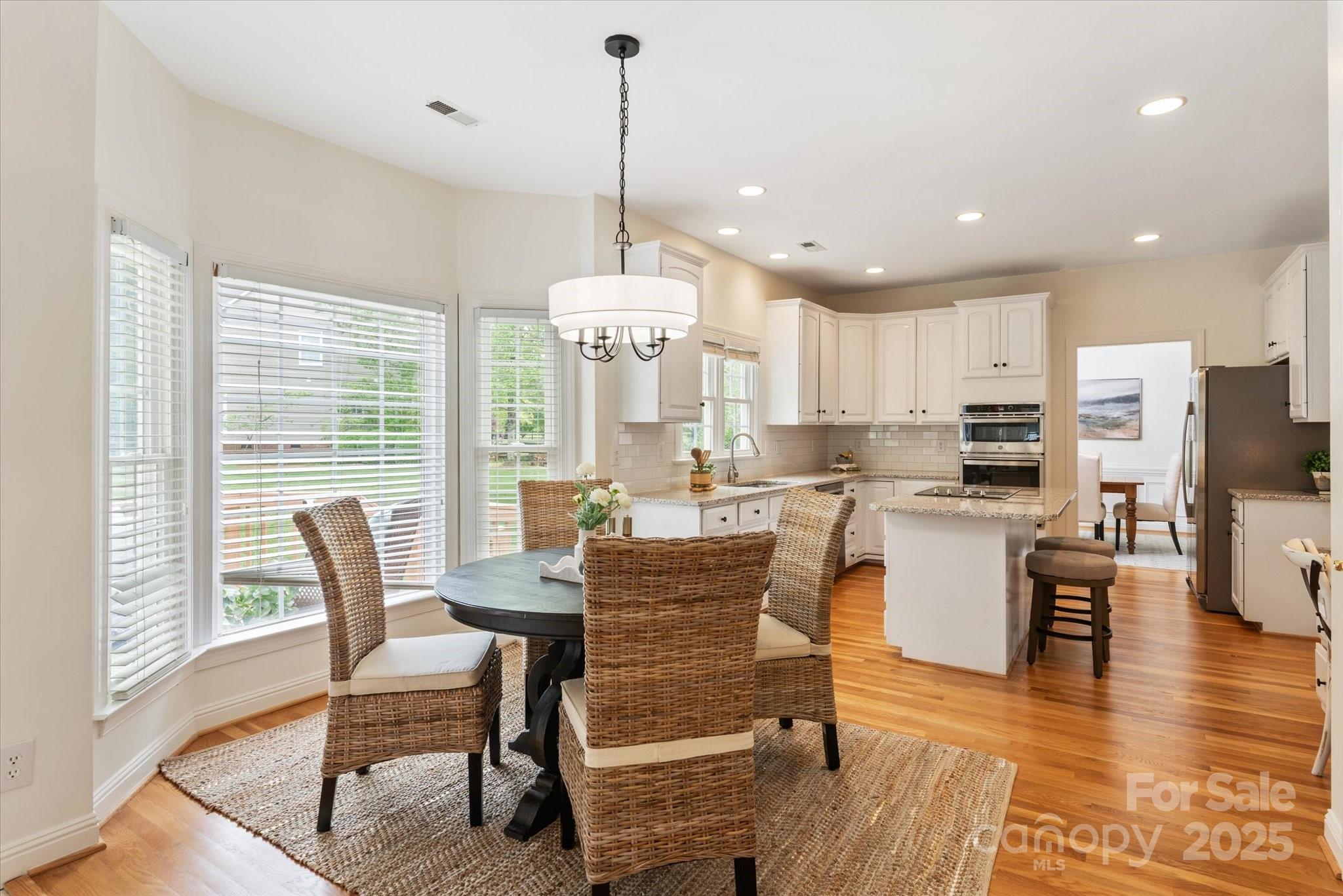 1006 Baldwin Lane Waxhaw, NC 28173 - Photo 15 of 42 a view of a dining room with furniture window and wooden floor