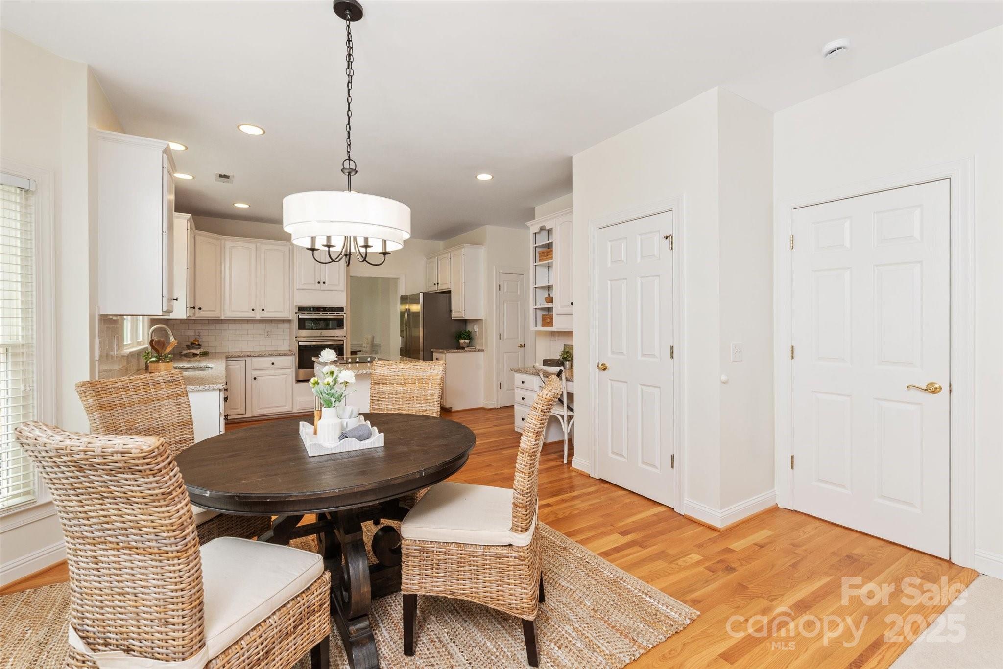 1006 Baldwin Lane Waxhaw, NC 28173 - Photo 16 of 42 a kitchen with a dining table and chairs