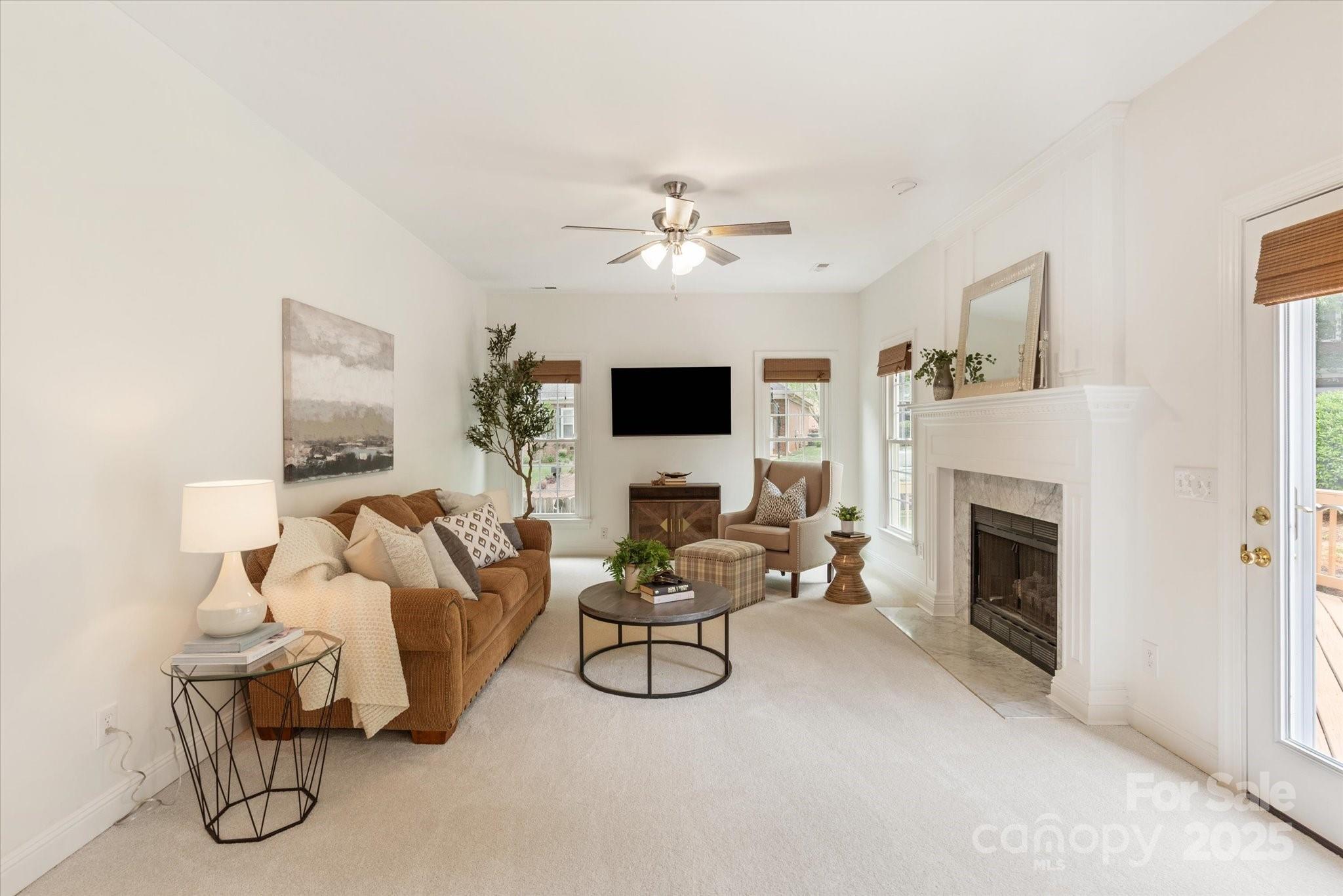 1006 Baldwin Lane Waxhaw, NC 28173 - Photo 17 of 42 a living room with furniture a fireplace and a flat screen tv