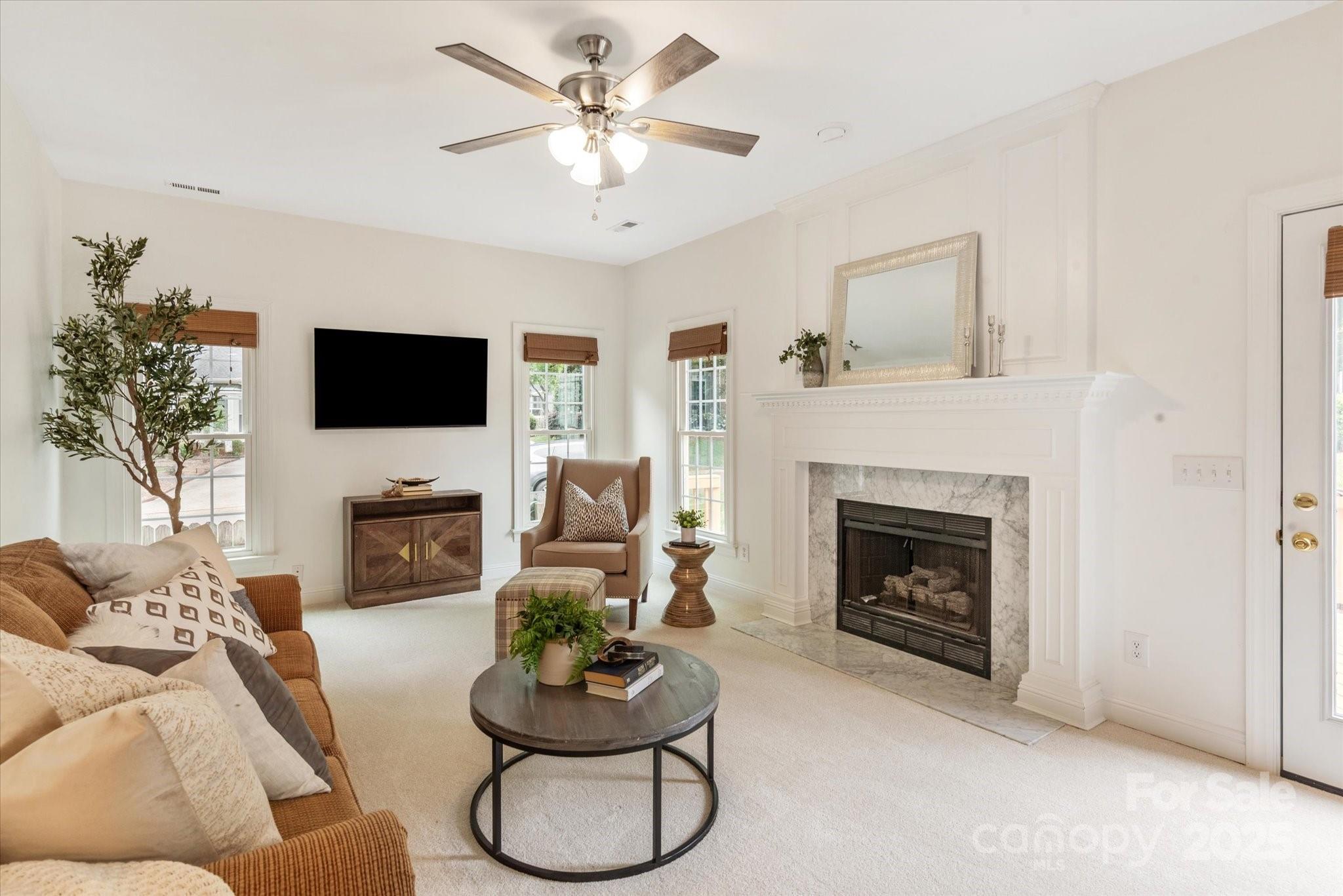 1006 Baldwin Lane Waxhaw, NC 28173 - Photo 18 of 42 a living room with furniture a fireplace and a flat screen tv
