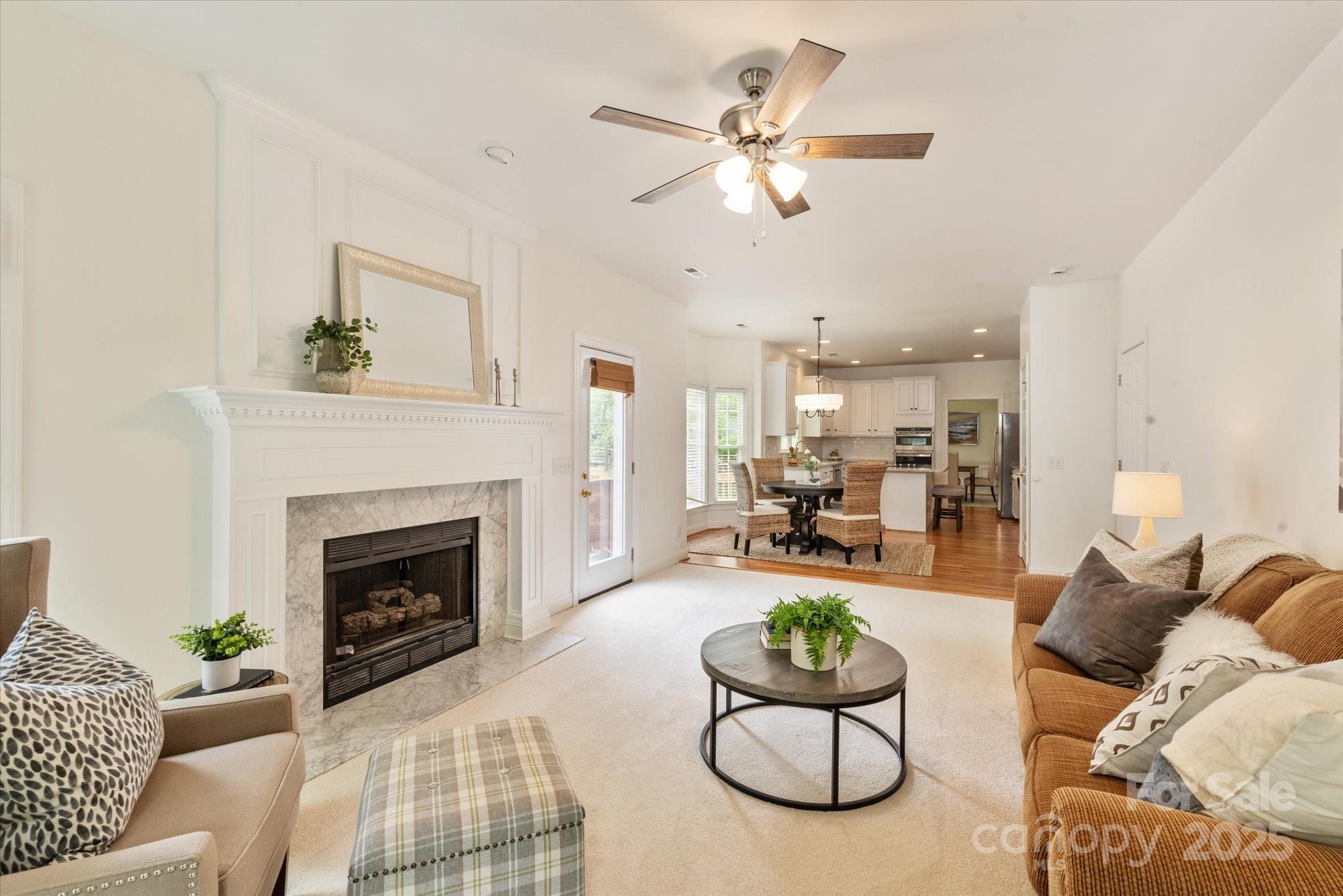 1006 Baldwin Lane Waxhaw, NC 28173 - Photo 20 of 42 a living room with furniture fireplace and a chandelier