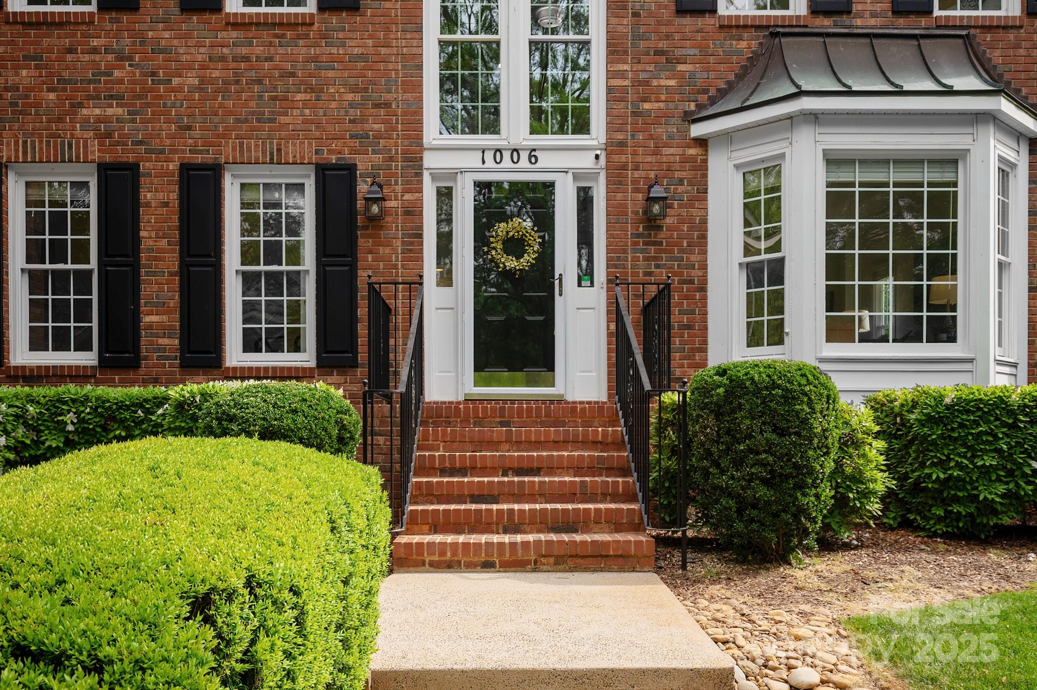 1006 Baldwin Lane Waxhaw, NC 28173 - Photo 2 of 42 a front view of a house with a garden