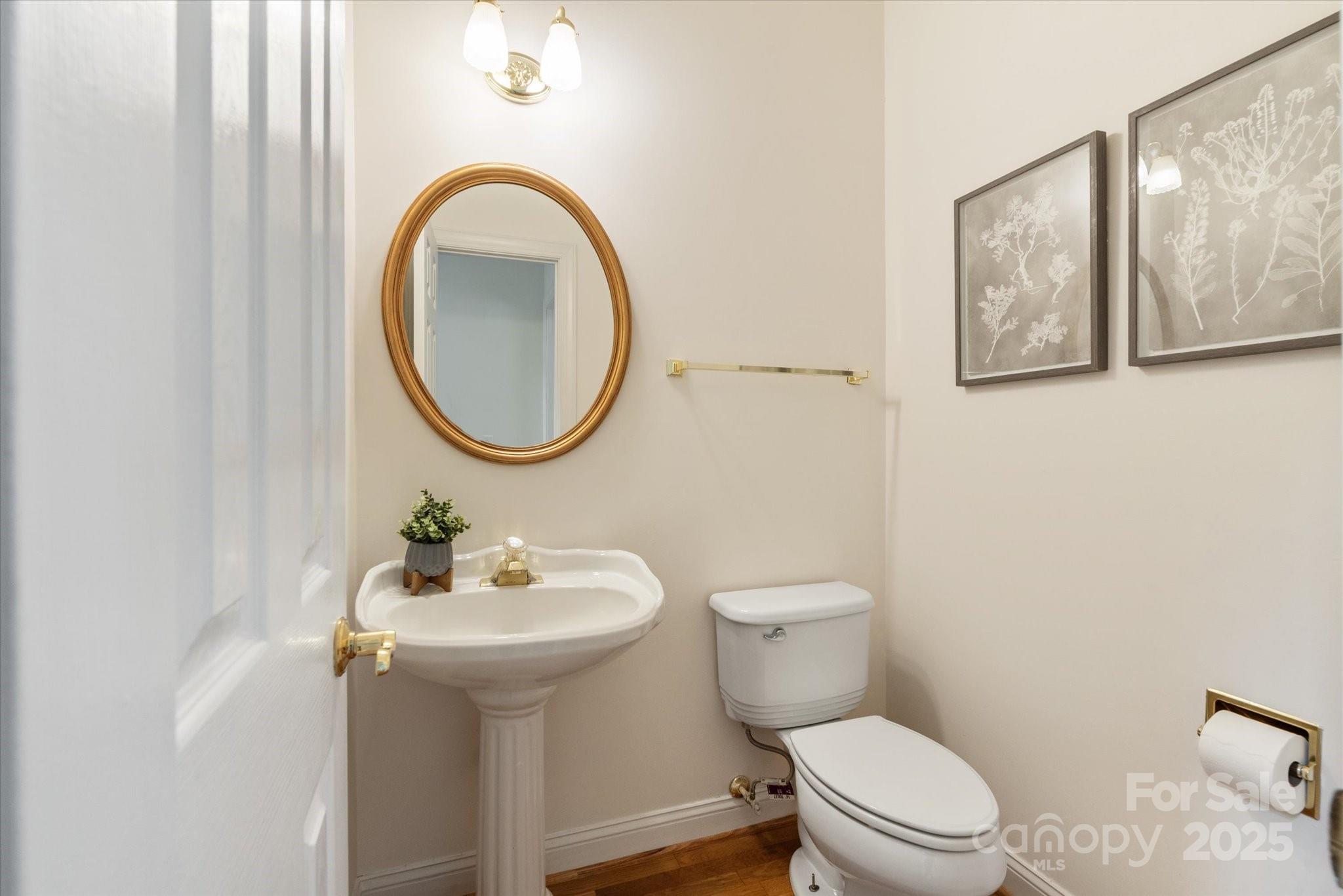 1006 Baldwin Lane Waxhaw, NC 28173 - Photo 21 of 42 a bathroom with a toilet a sink and mirror
