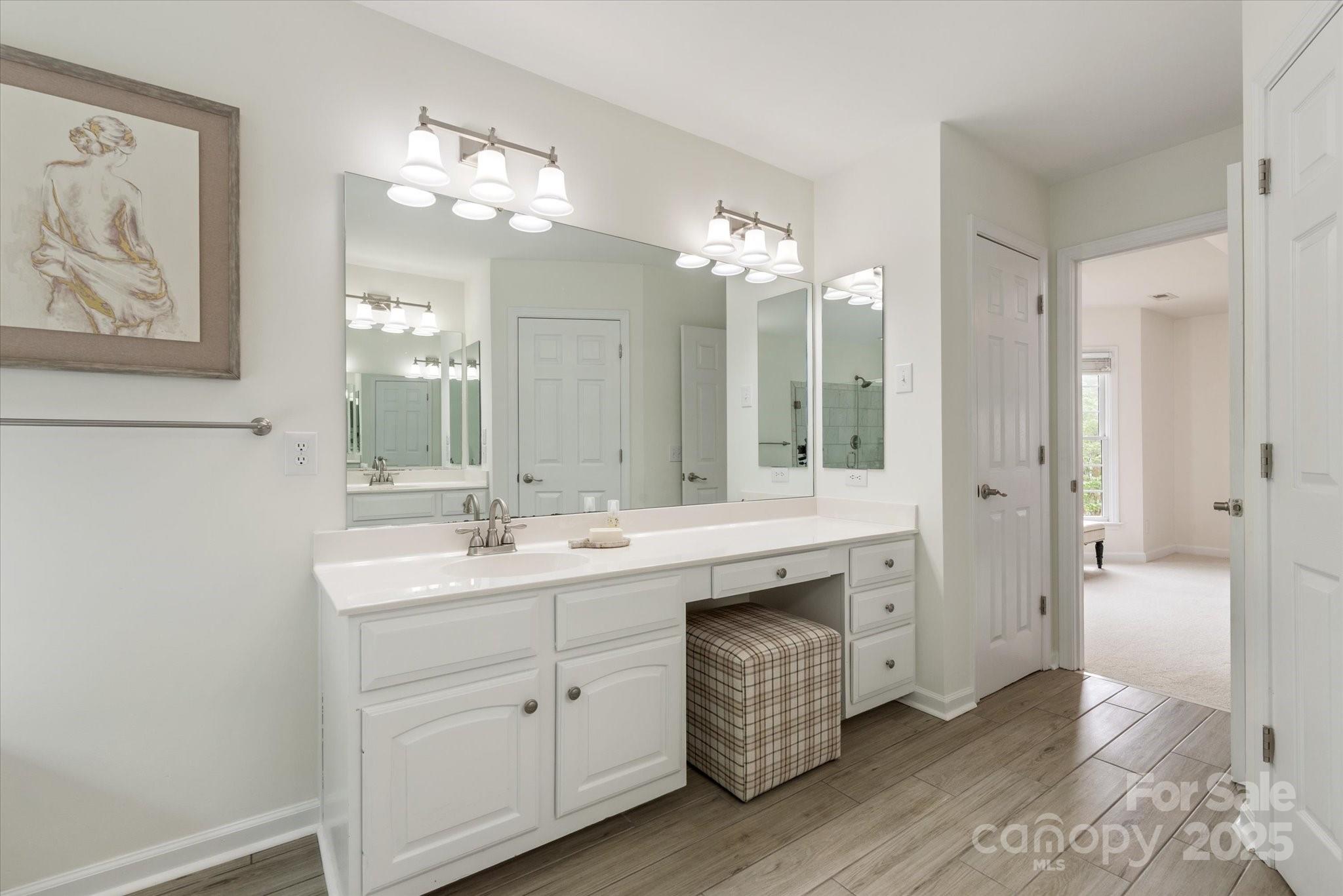 1006 Baldwin Lane Waxhaw, NC 28173 - Photo 26 of 42 a spacious bathroom with a double vanity sink mirror and double