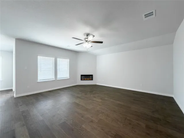 a kitchen with a sink and wooden floor
