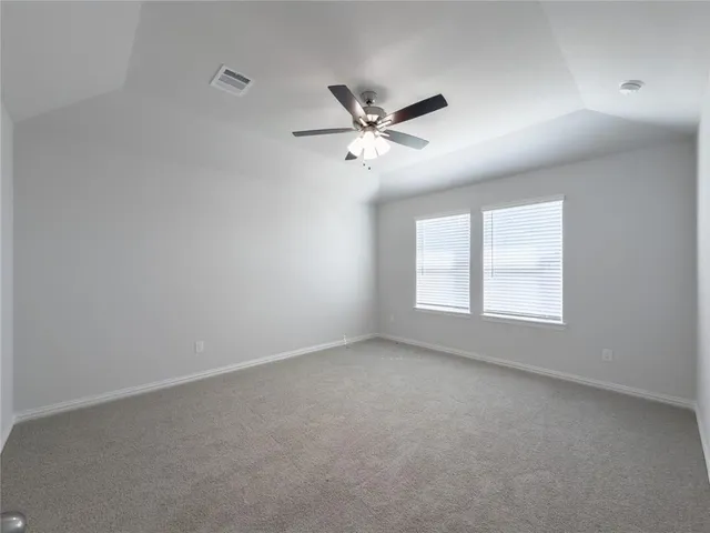 a view of kitchen with kitchen island wooden floor and refrigerator