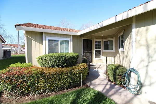 a front view of a house with garden