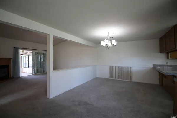 a view of empty room with a fireplace