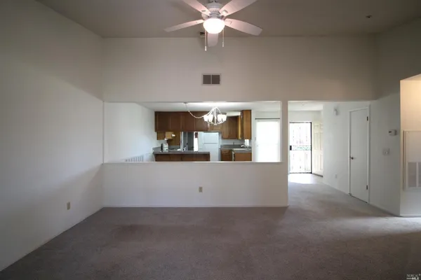 a kitchen with a sink refrigerator and cabinets