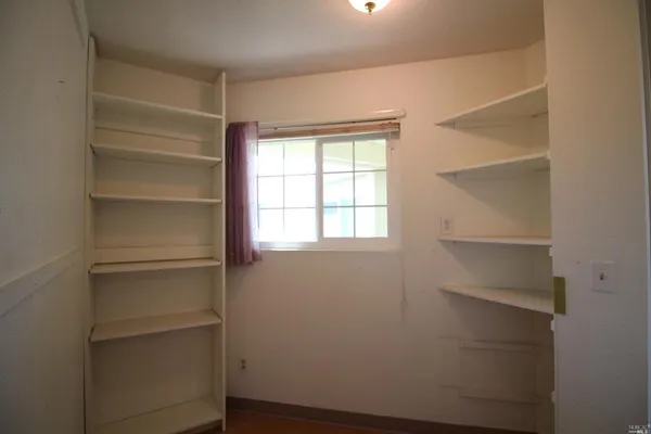 a view of empty room with large windows