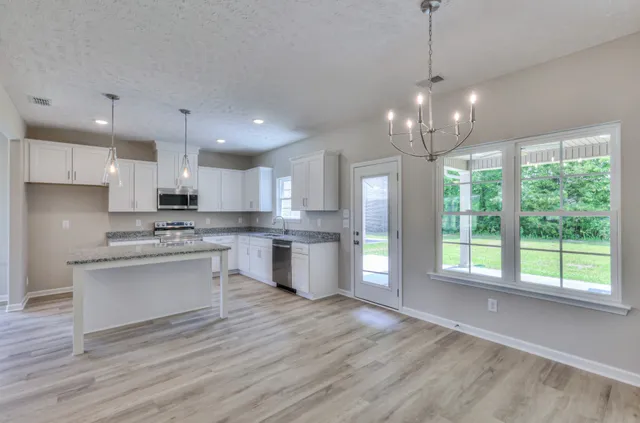 a large kitchen with granite countertop lots of counter top space