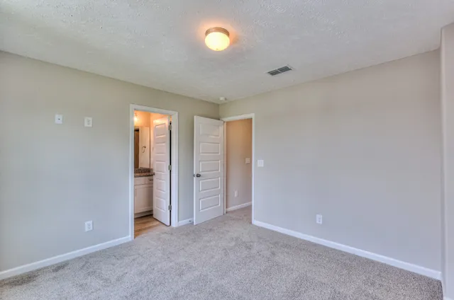 an empty room with closet area