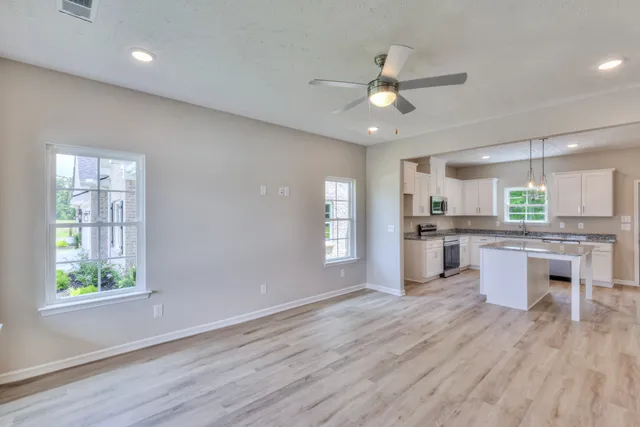 a view of kitchen with refrigerator microwave and wooden floor
