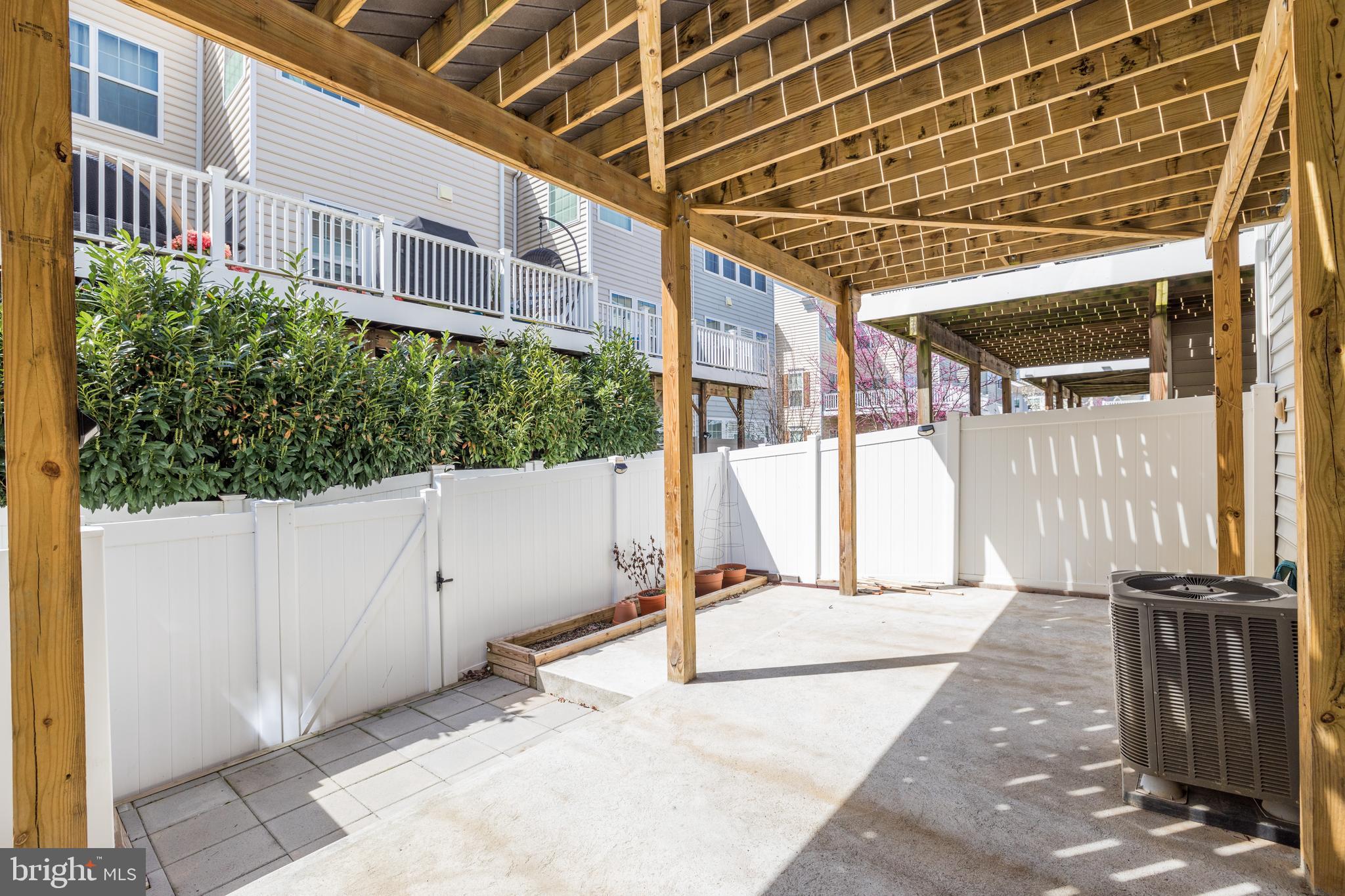 43583 White Cap Terrace Chantilly, VA 20152 - Photo 13 of 18 a view of a porch with wooden floor and a bench