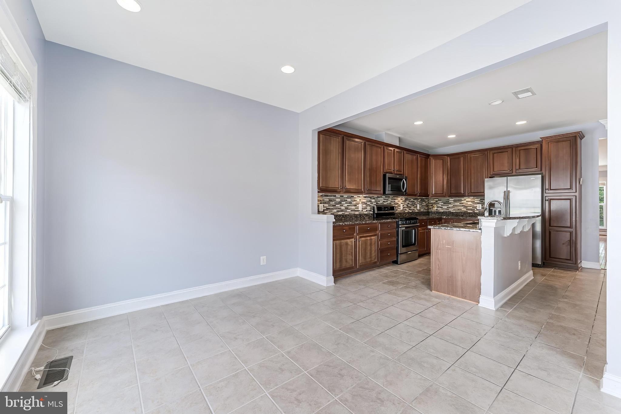 43583 White Cap Terrace Chantilly, VA 20152 - Photo 14 of 55 a kitchen with a refrigerator and a stove top oven