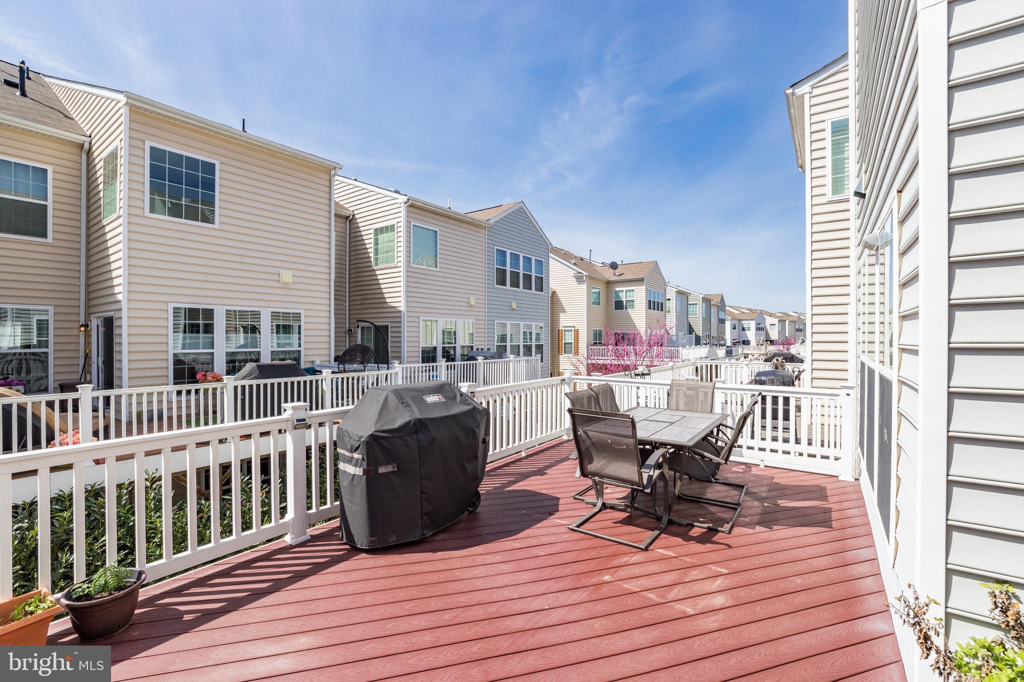 43583 White Cap Terrace Chantilly, VA 20152 - Photo 15 of 18 a view of a deck with table and chairs and wooden floor