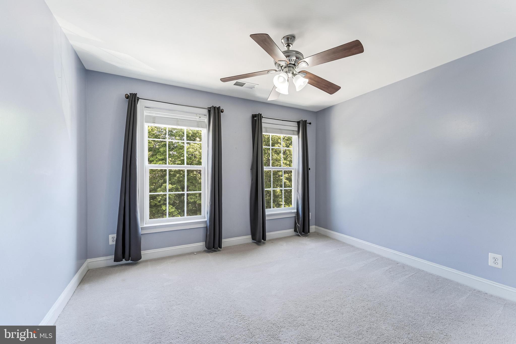 43583 White Cap Terrace Chantilly, VA 20152 - Photo 38 of 55 an empty room with windows fan and a ceiling fan