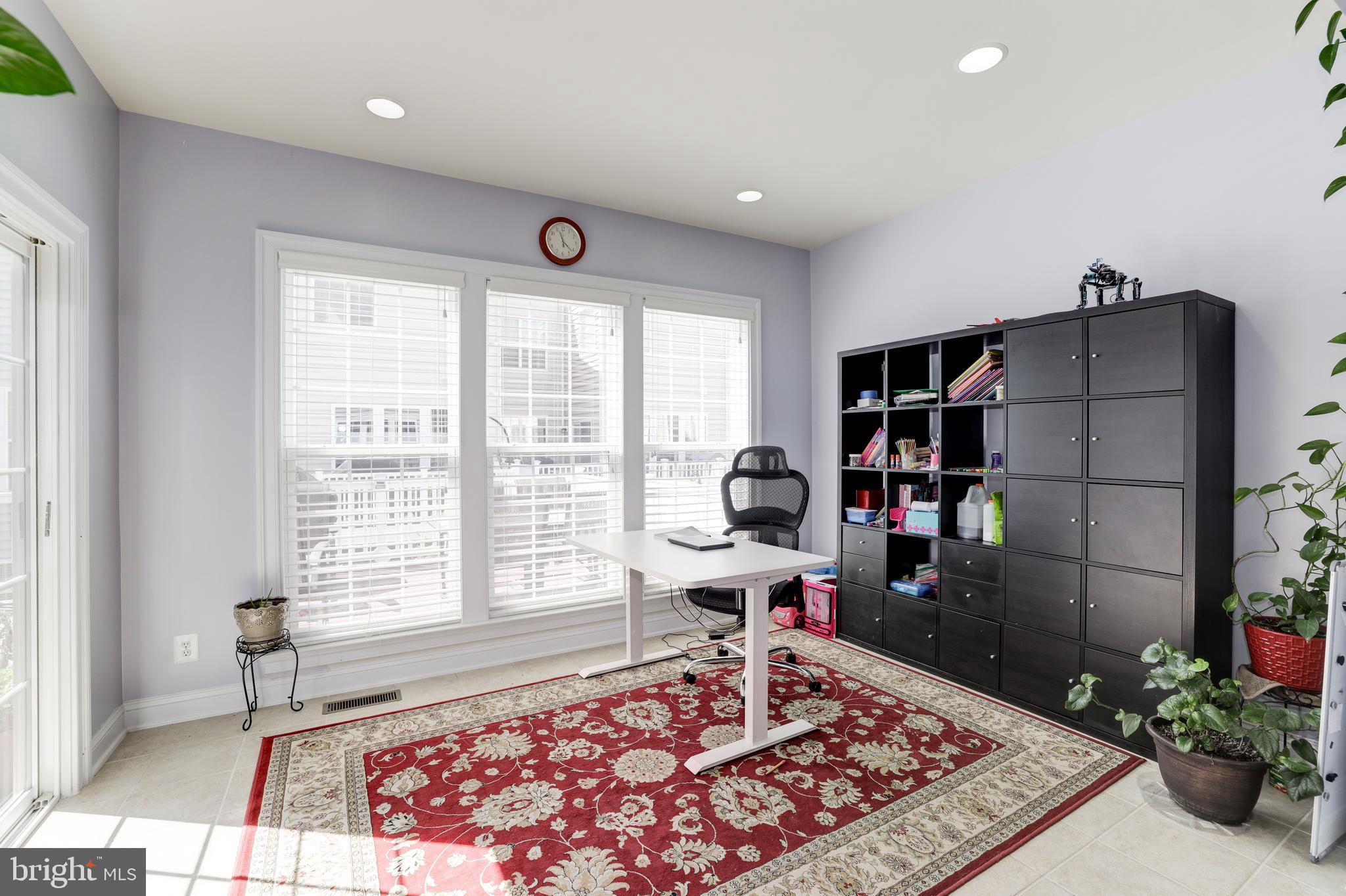43583 White Cap Terrace Chantilly, VA 20152 - Photo 4 of 18 a living room with a couch and a bookshelf