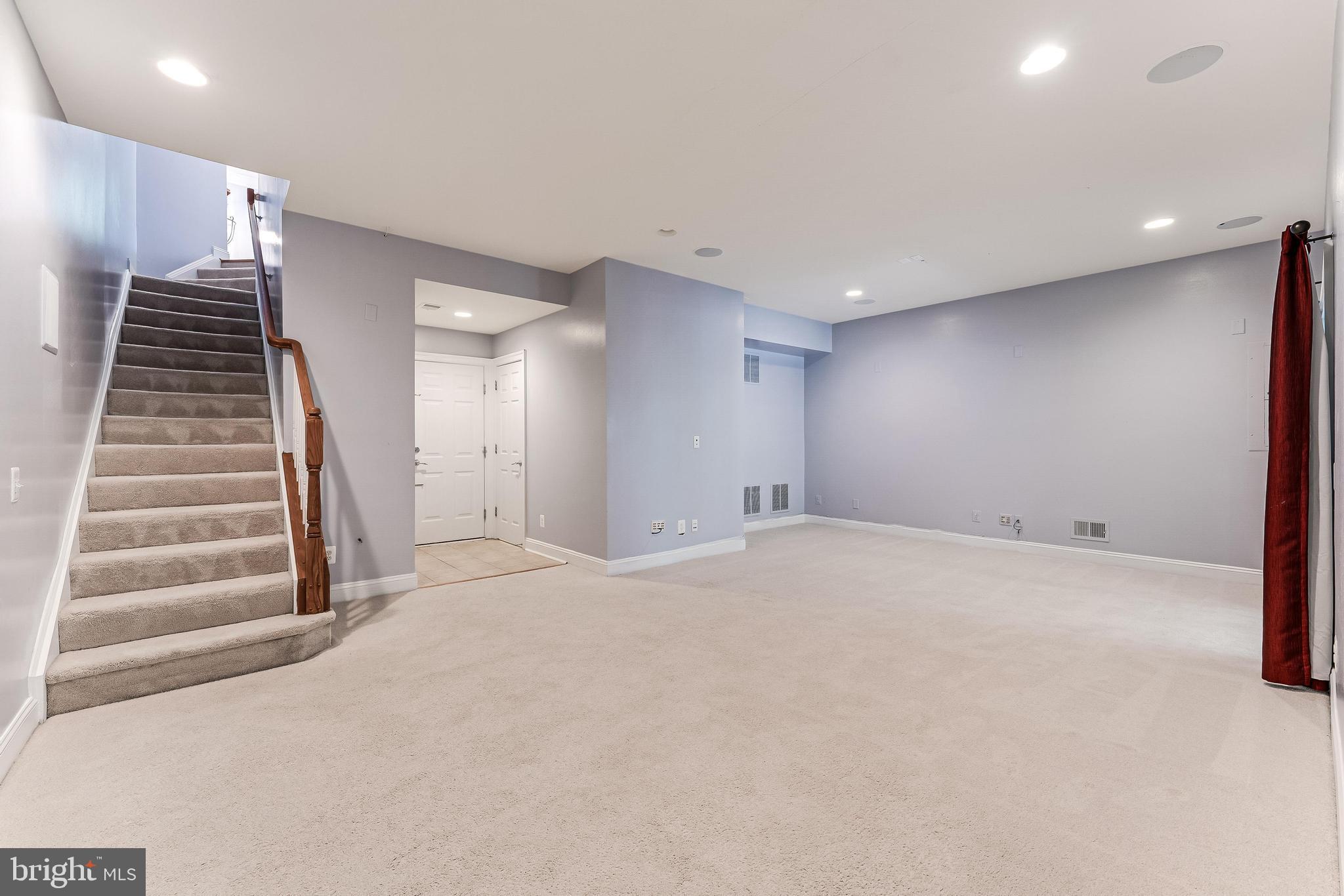 43583 White Cap Terrace Chantilly, VA 20152 - Photo 45 of 55 a view of an empty room with wooden floor and stairs