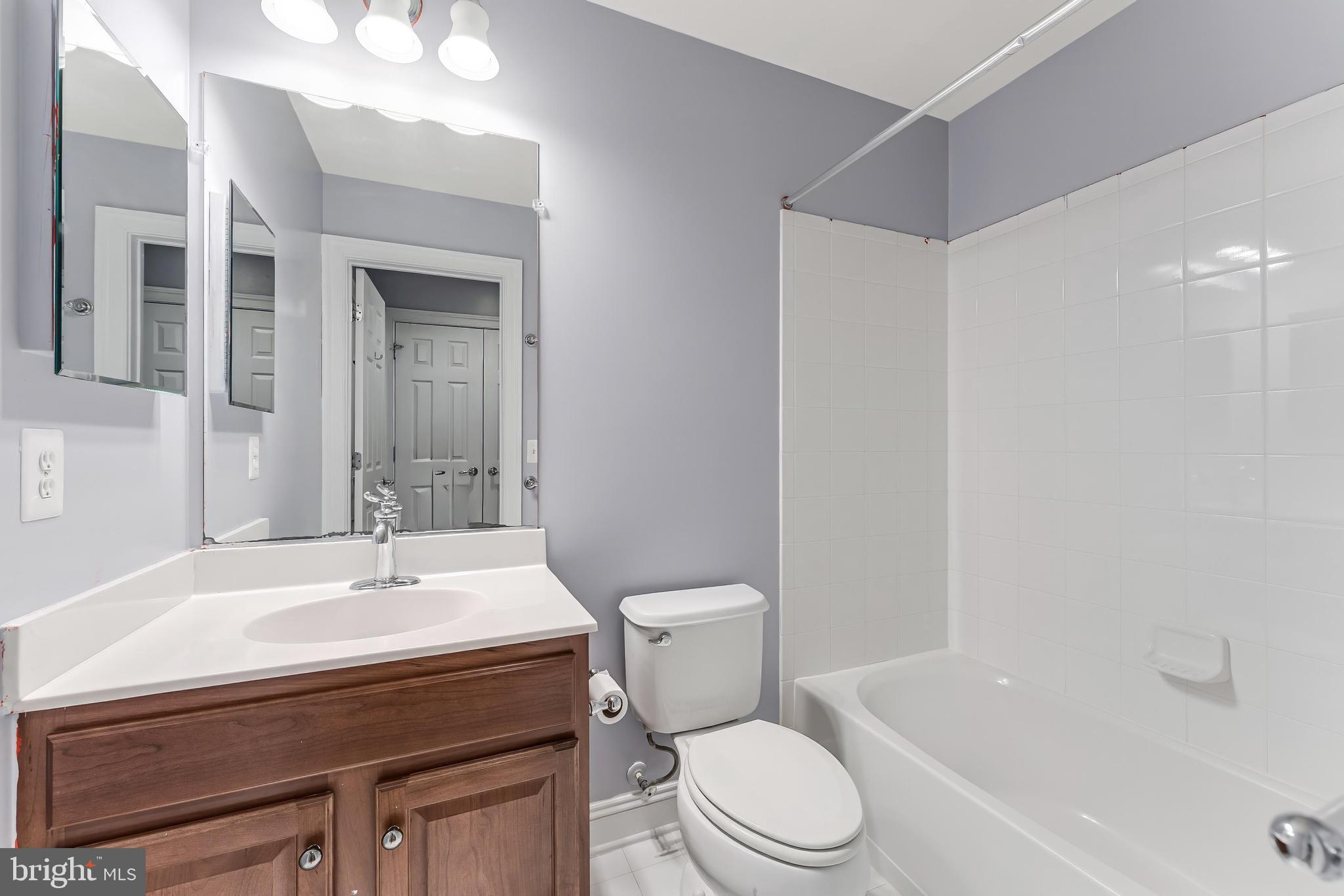 43583 White Cap Terrace Chantilly, VA 20152 - Photo 49 of 55 a bathroom with a sink toilet a mirror and shower