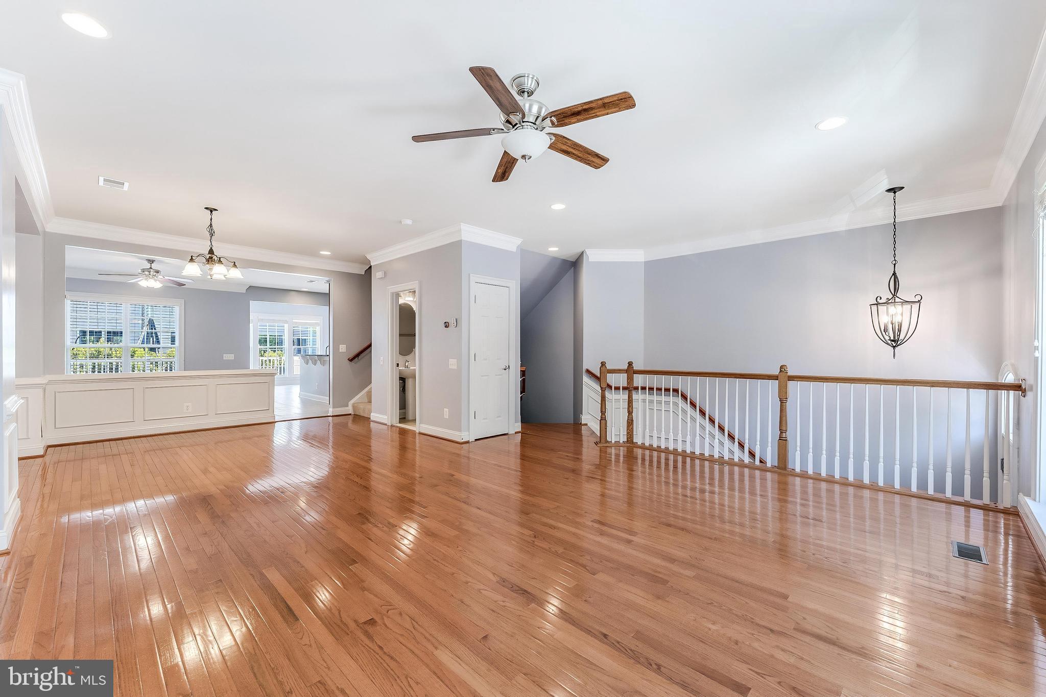 43583 White Cap Terrace Chantilly, VA 20152 - Photo 5 of 55 a view of an empty room with wooden floor and a ceiling fan