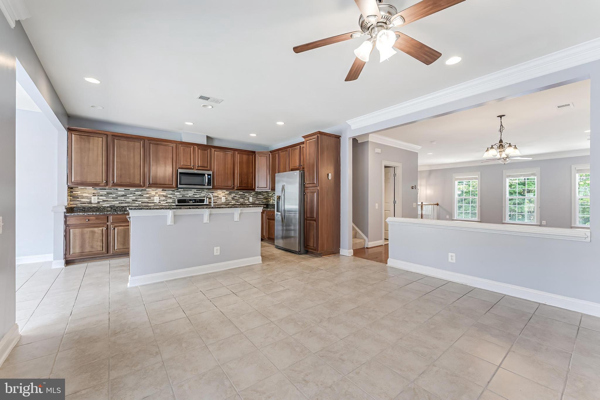 43583 White Cap Terrace Chantilly, VA 20152 - Photo 7 of 55 a view of kitchen with refrigerator stove microwave and cabinets