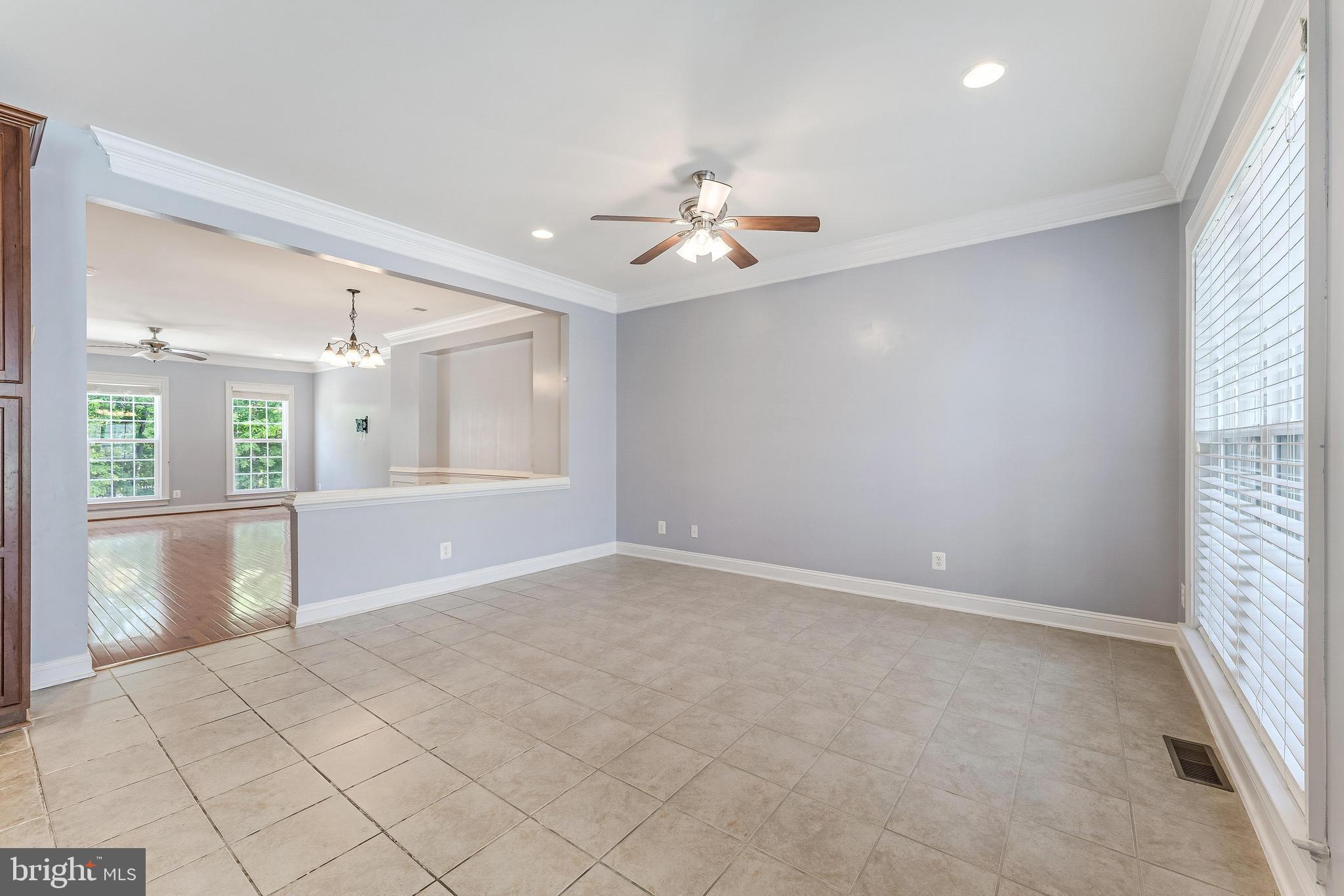 43583 White Cap Terrace Chantilly, VA 20152 - Photo 10 of 55 an empty room with chandelier fan and windows