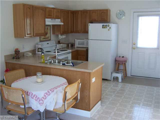 4909 Gold Crest Drive Oak Ridge, NC 27310 - Photo 14 of 16 In-Law Suite. Kitchen and Dining area of in-law suite. Lots of cabinets!