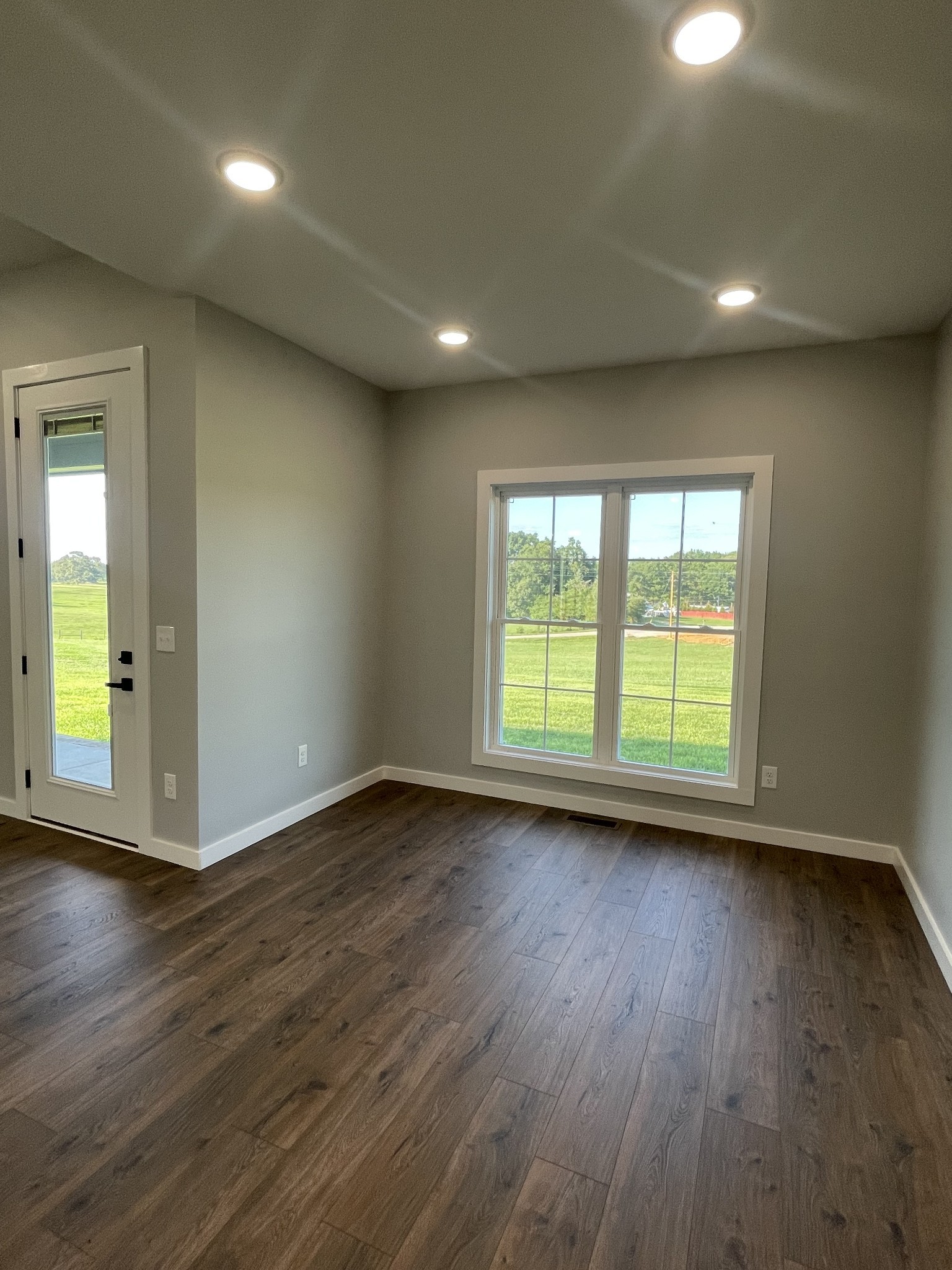 1456 Fall River Road Lawrenceburg, TN 38464 - Photo 12 of 30 an empty room with wooden floor and windows