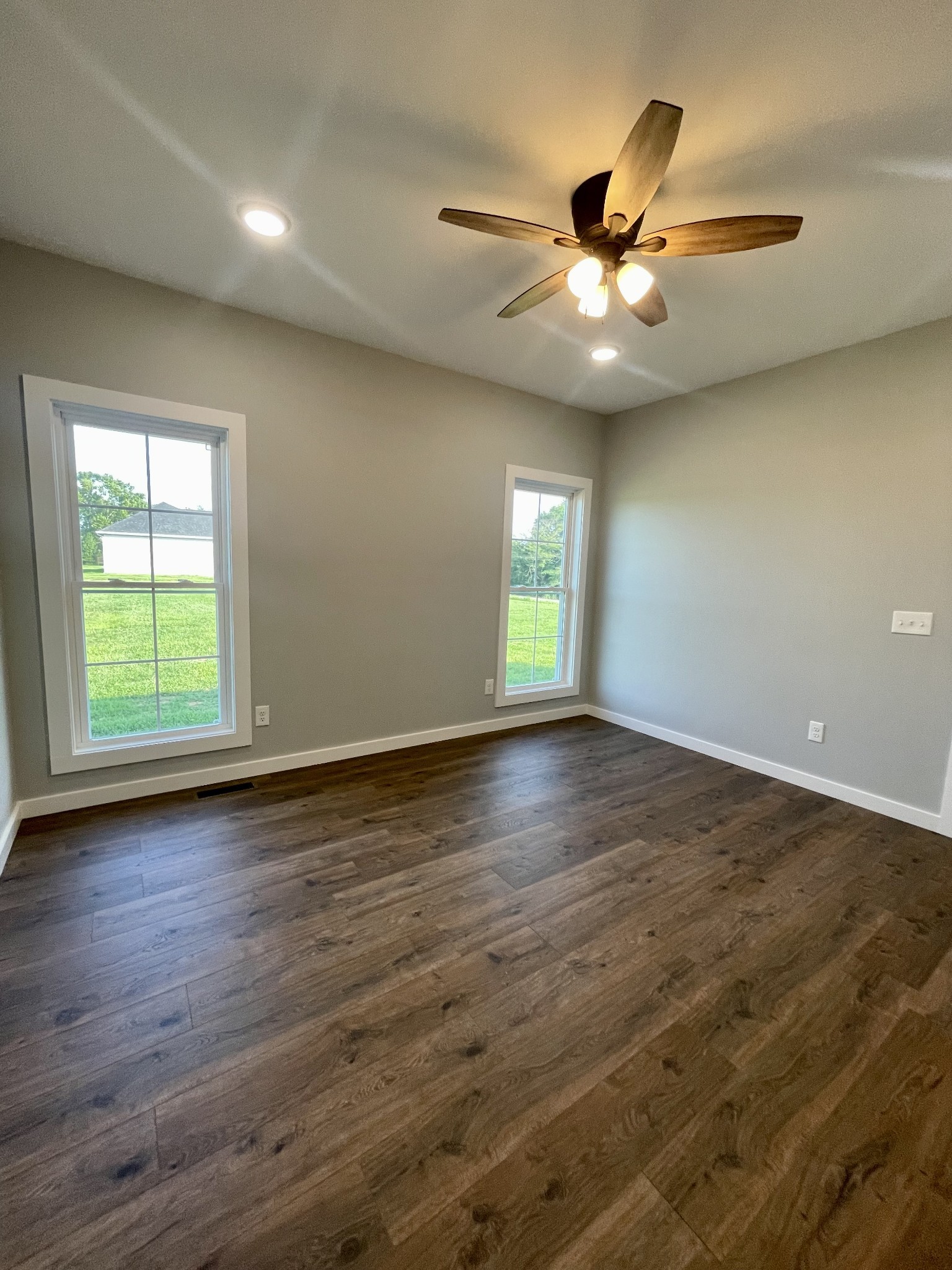 1456 Fall River Road Lawrenceburg, TN 38464 - Photo 19 of 30 an empty room with wooden floor fan and windows
