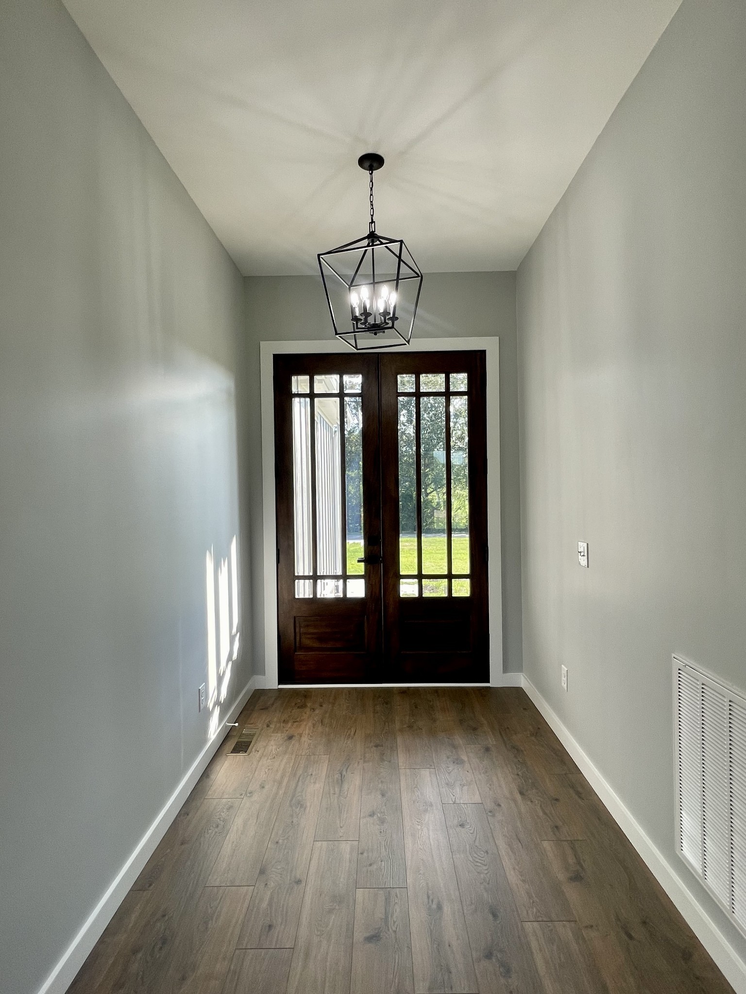 1456 Fall River Road Lawrenceburg, TN 38464 - Photo 3 of 30 an empty room with wooden floor and windows