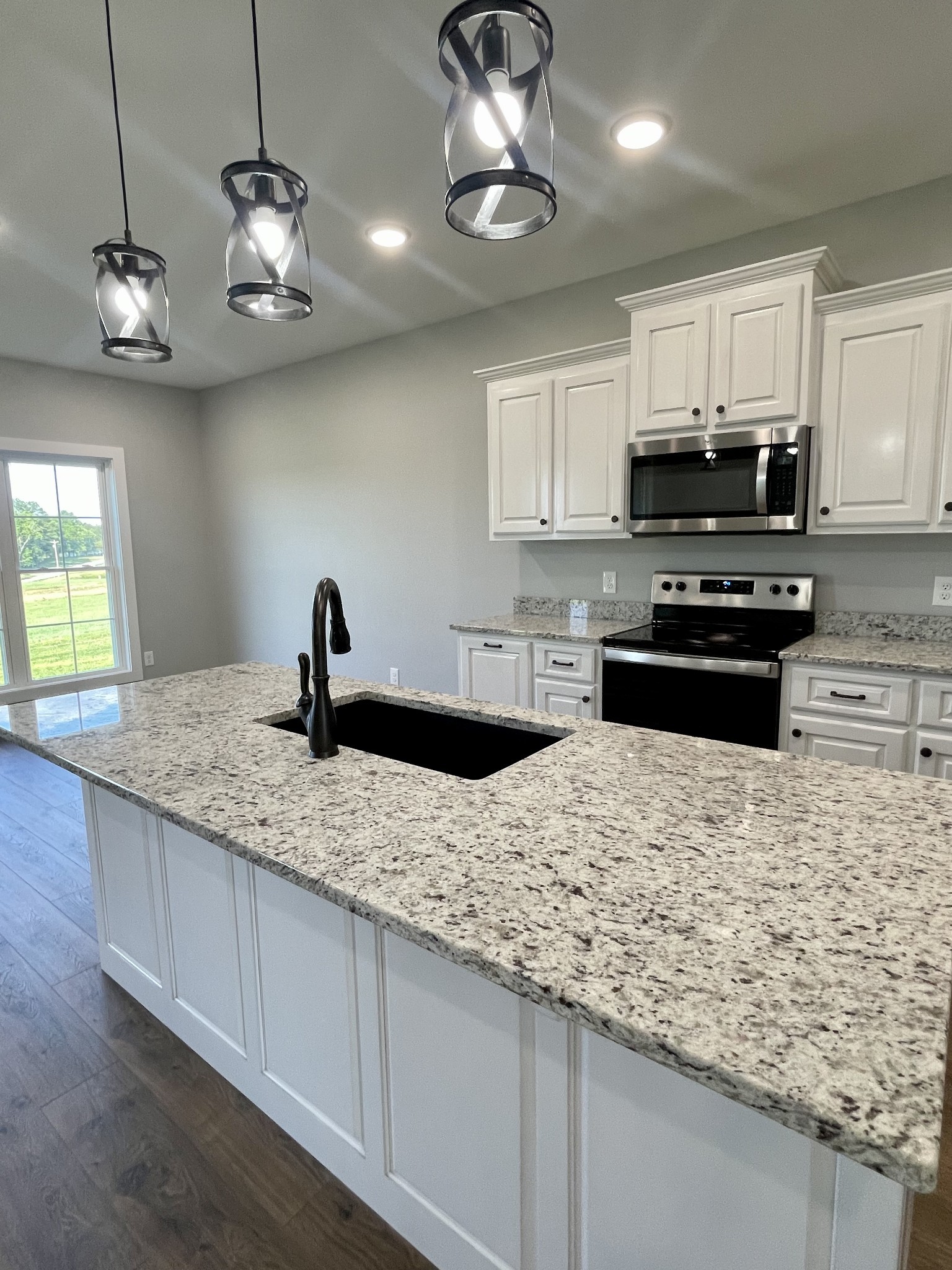 1456 Fall River Road Lawrenceburg, TN 38464 - Photo 7 of 30 a kitchen with stainless steel appliances granite countertop a sink stove and refrigerator