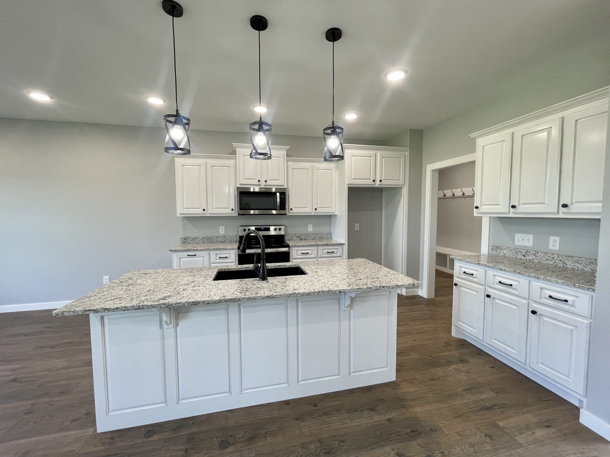 1456 Fall River Road Lawrenceburg, TN 38464 - Photo 10 of 30 a kitchen with kitchen island granite countertop a sink a center island stainless steel appliances and cabinets