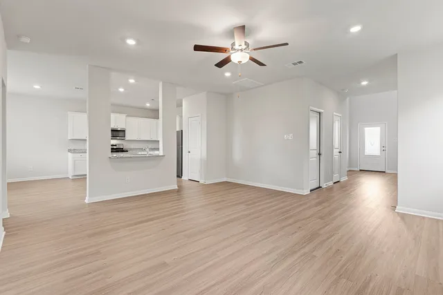 a kitchen with stainless steel appliances a refrigerator sink and white cabinets