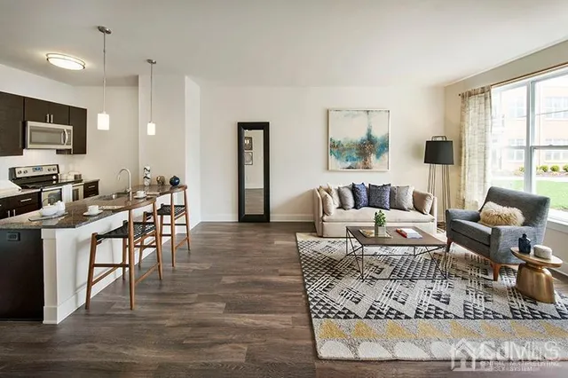 a living room with furniture kitchen and a table