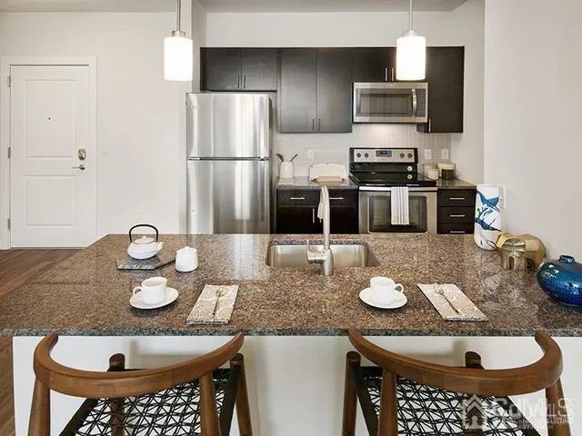 a bedroom with two beds and a chair