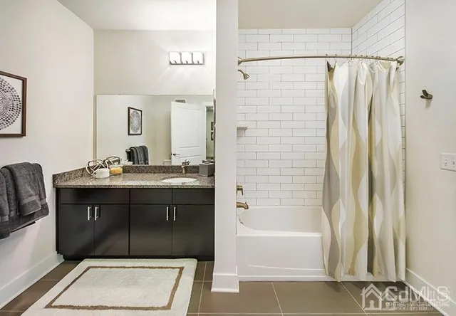 a bathroom with a sink vanity mirror and bathtub