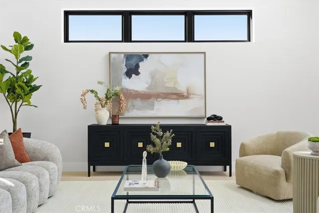 a dining room with wooden floor a chandelier a wooden table and chairs