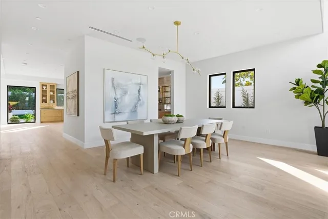 a living room with furniture and large windows