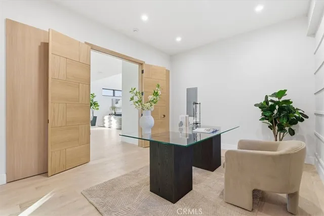 a living room with furniture a flat screen tv and a large window