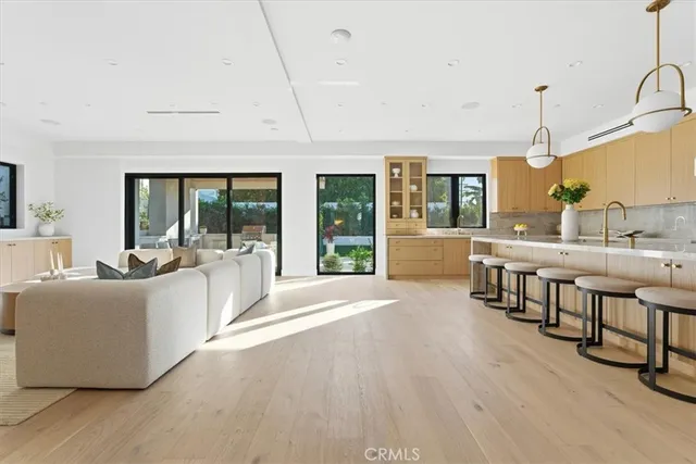 a kitchen with table chairs cabinets and window