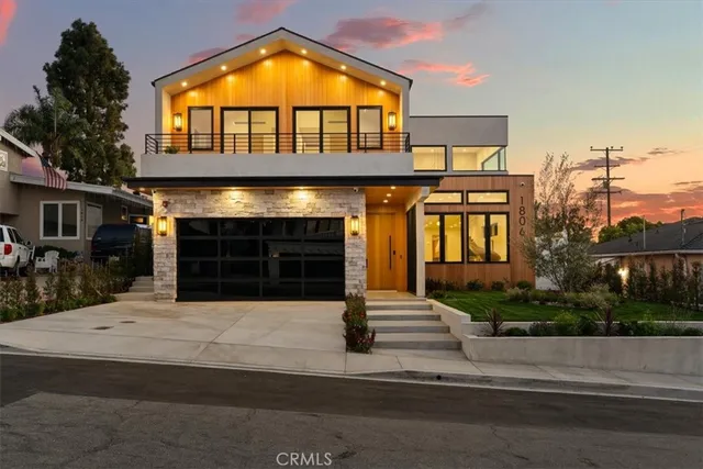 a living room with furniture a floor to ceiling window and a kitchen view