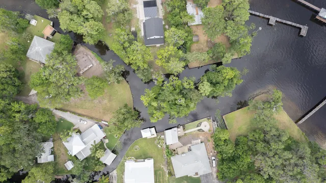 an aerial view of a house with a yard and garden