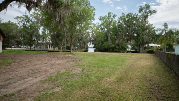 a view of a field with trees in front of it