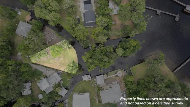 an aerial view of a house with a yard and trees