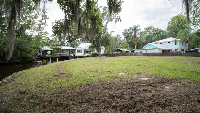 a view of a house with yard and sitting area
